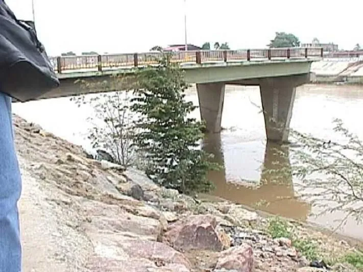 The remains of a road bridge in Piura, Peru, its deck collapsed into the river.