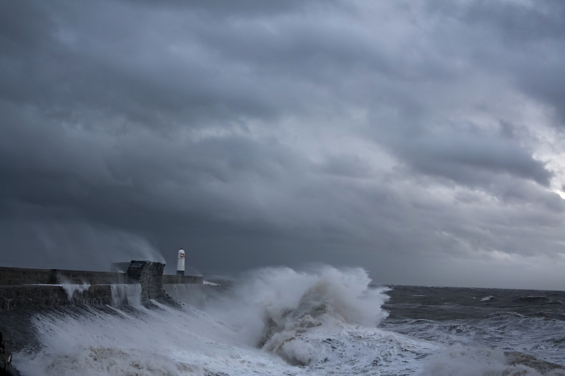 Illustrative photo: storm waves breaking over the harbour wall and lighthouse at Porthcawl, south Wales