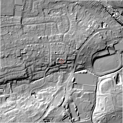 Shaded relief map of the ground around B911SE, computed from Environment Agency LiDAR. The ground here sits at about 130 m above sea level and falls 13 m across the surrounding 800 m. Surface water reaching this point runs off ground lying to the north, 2.8 m higher.