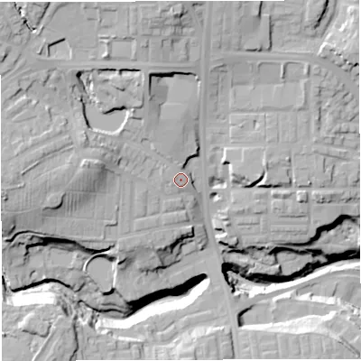 Shaded relief map of the ground around BL16NJ, computed from Environment Agency LiDAR. The ground here sits at about 112 m above sea level and falls 38 m across the surrounding 800 m. Surface water reaching this point runs off ground lying to the north-west, 15.6 m higher.