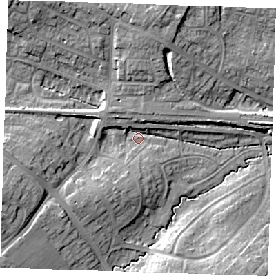 Shaded relief map of the ground around BN265AF, computed from Environment Agency LiDAR. The ground here sits at about 12 m above sea level and falls 16 m across the surrounding 800 m. Surface water reaching this point runs off ground lying to the west, 10.2 m higher.