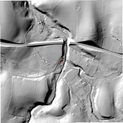 Shaded relief map of the ground around CA174LT, computed from Environment Agency LiDAR. The ground here sits at about 242 m above sea level and falls 43 m across the surrounding 800 m. Surface water reaching this point runs off ground lying to the south-west, 35.1 m higher.