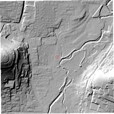 Shaded relief map of the ground around DT65DE, computed from Environment Agency LiDAR. The ground here sits at about 9 m above sea level and falls 71 m across the surrounding 800 m. Surface water reaching this point runs off ground lying to the west-north-west, 6.3 m higher.