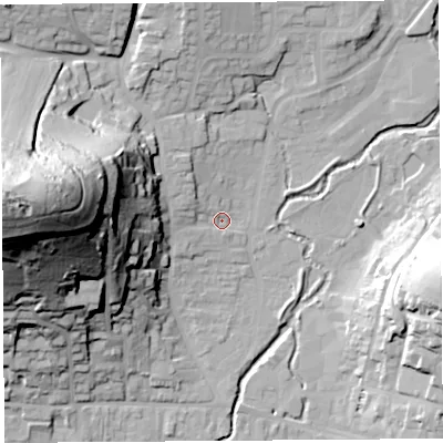 Shaded relief map of the ground around DT65DW, computed from Environment Agency LiDAR. The ground here sits at about 10 m above sea level and falls 77 m across the surrounding 800 m. Surface water reaching this point runs off ground lying to the west, 73.1 m higher.