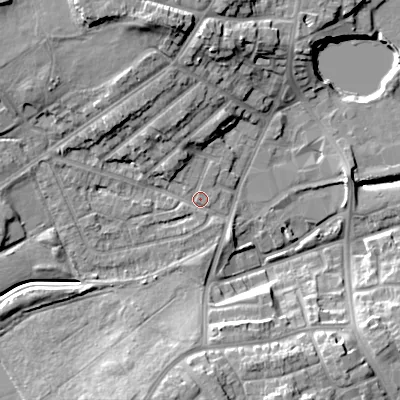 Shaded relief map of the ground around DY40JS, computed from Environment Agency LiDAR. The ground here sits at about 127 m above sea level and falls 17 m across the surrounding 800 m. Surface water reaching this point runs off ground lying to the north-north-west, 12.0 m higher.