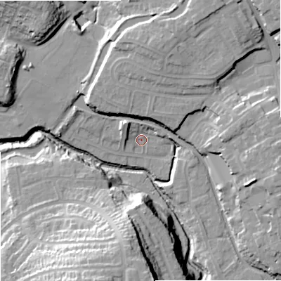 Shaded relief map of the ground around DY84XF, computed from Environment Agency LiDAR. The ground here sits at about 63 m above sea level and falls 36 m across the surrounding 800 m. Surface water reaching this point runs off ground lying to the north-west, 6.1 m higher.