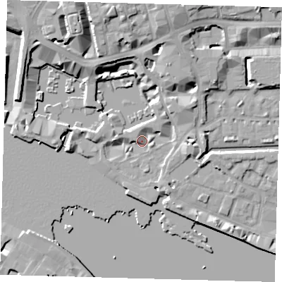 Shaded relief map of the ground around E1W1ND, computed from Environment Agency LiDAR. The ground here sits at about 5 m above sea level and falls 13 m across the surrounding 800 m. Surface water reaching this point runs off ground lying to the north-north-west, 11.4 m higher.