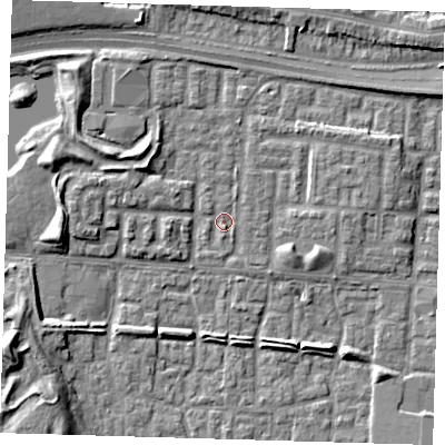 Shaded relief map of the ground around E65XB, computed from Environment Agency LiDAR. The ground here sits at about 1 m above sea level and falls 9 m across the surrounding 800 m. Surface water reaching this point runs off ground lying to the south, 1.0 m higher.