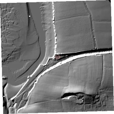 Shaded relief map of the ground around EX312NH, computed from Environment Agency LiDAR. The ground here sits at about 10 m above sea level and falls 34 m across the surrounding 800 m. Surface water reaching this point runs off ground lying to the north, 7.1 m higher.