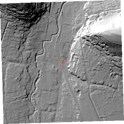 Shaded relief map of the ground around EX332JB, computed from Environment Agency LiDAR. The ground here sits at about 13 m above sea level and falls 84 m across the surrounding 800 m. Surface water reaching this point runs off ground lying to the east-north-east, 76.4 m higher.