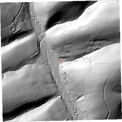 Shaded relief map of the ground around EX67AF, computed from Environment Agency LiDAR. The ground here sits at about 77 m above sea level and falls 73 m across the surrounding 800 m. Surface water reaching this point runs off ground lying to the north-east, 67.3 m higher.