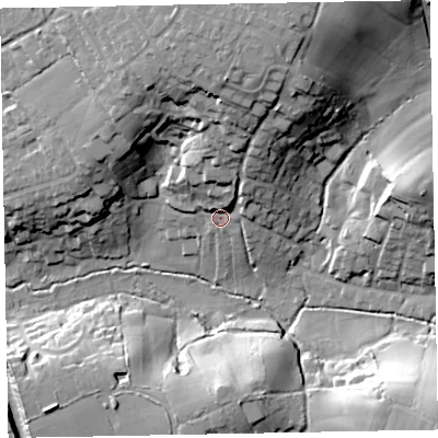 Shaded relief map of the ground around EX85JX, computed from Environment Agency LiDAR. The ground here sits at about 13 m above sea level and falls 36 m across the surrounding 800 m. Surface water reaching this point runs off ground lying to the north, 25.3 m higher.