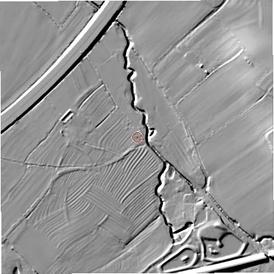 Shaded relief map of the ground around GL115DR, computed from Environment Agency LiDAR. The ground here sits at about 18 m above sea level and falls 23 m across the surrounding 800 m. Surface water reaching this point runs off ground lying to the east-north-east, 21.8 m higher.