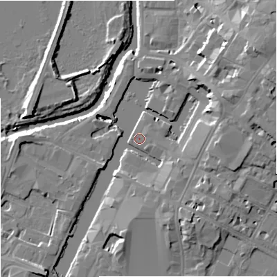 Shaded relief map of the ground around GL12BY, computed from Environment Agency LiDAR. The ground here sits at about 11 m above sea level and falls 15 m across the surrounding 800 m. Surface water reaching this point runs off ground lying to the east-north-east, 12.1 m higher.