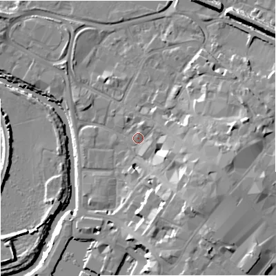 Shaded relief map of the ground around GL12JD, computed from Environment Agency LiDAR. The ground here sits at about 12 m above sea level and falls 15 m across the surrounding 800 m. Surface water reaching this point runs off ground lying to the south-east, 9.5 m higher.