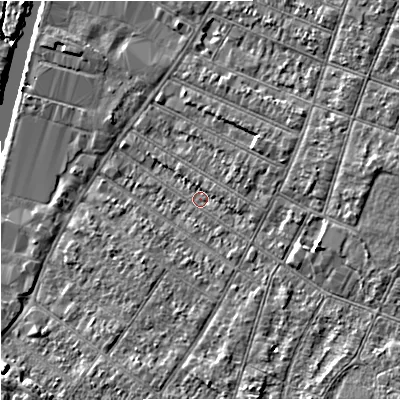 Shaded relief map of the ground around GL15HB, computed from Environment Agency LiDAR. The ground here sits at about 12 m above sea level and falls 7 m across the surrounding 800 m. Surface water reaching this point runs off ground lying to the east, 4.7 m higher.