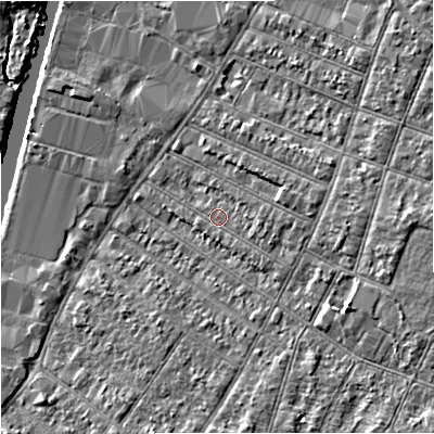 Shaded relief map of the ground around GL15QE, computed from Environment Agency LiDAR. The ground here sits at about 12 m above sea level and falls 6 m across the surrounding 800 m. Surface water reaching this point runs off ground lying to the east, 2.1 m higher.