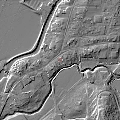 Shaded relief map of the ground around GL205PL, computed from Environment Agency LiDAR. The ground here sits at about 13 m above sea level and falls 12 m across the surrounding 800 m. Surface water reaching this point runs off ground lying to the east-north-east, 2.4 m higher.