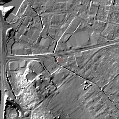 Shaded relief map of the ground around GL25ER, computed from Environment Agency LiDAR. The ground here sits at about 13 m above sea level and falls 15 m across the surrounding 800 m. Surface water reaching this point runs off ground lying to the south, 12.9 m higher.