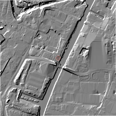 Shaded relief map of the ground around GL25GQ, computed from Environment Agency LiDAR. The ground here sits at about 12 m above sea level and falls 11 m across the surrounding 800 m. Surface water reaching this point runs off ground lying to the south-south-east, 6.6 m higher.