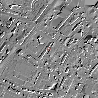 Shaded relief map of the ground around GL501QX, computed from Environment Agency LiDAR. The ground here sits at about 59 m above sea level and falls 16 m across the surrounding 800 m. Surface water reaching this point runs off ground lying to the south-south-west, 9.8 m higher.