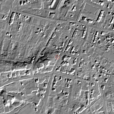 Shaded relief map of the ground around GL502RE, computed from Environment Agency LiDAR. The ground here sits at about 64 m above sea level and falls 15 m across the surrounding 800 m. Surface water reaching this point runs off ground lying to the south-east, 9.4 m higher.