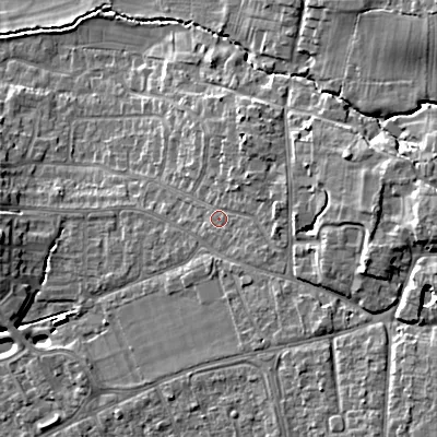 Shaded relief map of the ground around GL523DP, computed from Environment Agency LiDAR. The ground here sits at about 70 m above sea level and falls 18 m across the surrounding 800 m. Surface water reaching this point runs off ground lying to the east-north-east, 3.5 m higher.