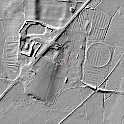 Shaded relief map of the ground around GL542EX, computed from Environment Agency LiDAR. The ground here sits at about 134 m above sea level and falls 11 m across the surrounding 800 m. Surface water reaching this point runs off ground lying to the north-west, 5.9 m higher.