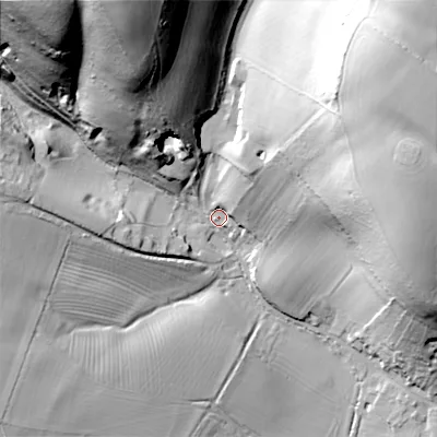 Shaded relief map of the ground around GL544HB, computed from Environment Agency LiDAR. The ground here sits at about 186 m above sea level and falls 72 m across the surrounding 800 m. Surface water reaching this point runs off ground lying to the north-east, 67.2 m higher.
