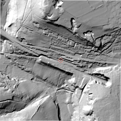 Shaded relief map of the ground around HX38HR, computed from Environment Agency LiDAR. The ground here sits at about 129 m above sea level and falls 115 m across the surrounding 800 m. Surface water reaching this point runs off ground lying to the east, 18.5 m higher.