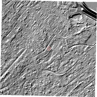Shaded relief map of the ground around KT122AA, computed from Environment Agency LiDAR. The ground here sits at about 12 m above sea level and falls 15 m across the surrounding 800 m. Surface water reaching this point runs off ground lying to the south-west, 1.1 m higher.