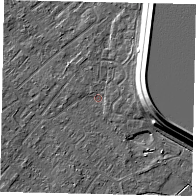 Shaded relief map of the ground around KT122AX, computed from Environment Agency LiDAR. The ground here sits at about 12 m above sea level and falls 15 m across the surrounding 800 m. Surface water reaching this point runs off ground lying to the east, 14.3 m higher.