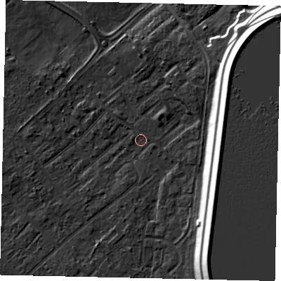 Shaded relief map of the ground around KT122EQ, computed from Environment Agency LiDAR. The ground here sits at about 11 m above sea level and falls 16 m across the surrounding 800 m. Surface water reaching this point runs off ground lying to the south-east, 14.8 m higher.