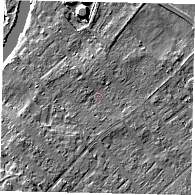 Shaded relief map of the ground around KT122HX, computed from Environment Agency LiDAR. The ground here sits at about 11 m above sea level and falls 12 m across the surrounding 800 m. Surface water reaching this point runs off ground lying to the south-west, 7.5 m higher.