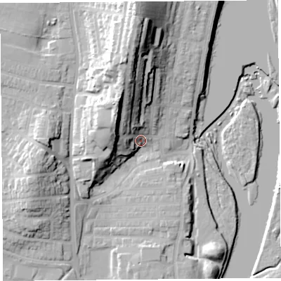 Shaded relief map of the ground around LA12DG, computed from Environment Agency LiDAR. The ground here sits at about 12 m above sea level and falls 34 m across the surrounding 800 m. Surface water reaching this point runs off ground lying to the north-north-west, 22.9 m higher.