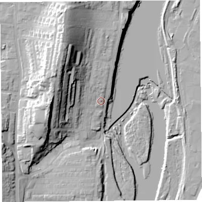 Shaded relief map of the ground around LA12EA, computed from Environment Agency LiDAR. The ground here sits at about 12 m above sea level and falls 34 m across the surrounding 800 m. Surface water reaching this point runs off ground lying to the north-west, 21.9 m higher.