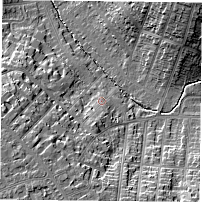 Shaded relief map of the ground around LE22BE, computed from Environment Agency LiDAR. The ground here sits at about 77 m above sea level and falls 23 m across the surrounding 800 m. Surface water reaching this point runs off ground lying to the south-south-west, 6.3 m higher.