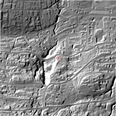 Shaded relief map of the ground around LS299PT, computed from Environment Agency LiDAR. The ground here sits at about 124 m above sea level and falls 122 m across the surrounding 800 m. Surface water reaching this point runs off ground lying to the south, 23.1 m higher.