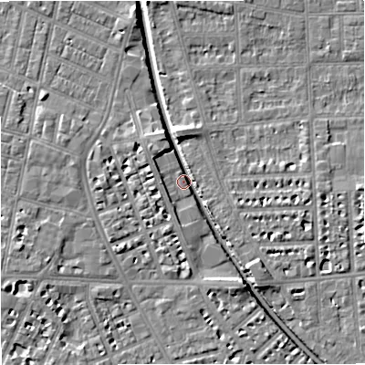 Shaded relief map of the ground around M210AZ, computed from Environment Agency LiDAR. The ground here sits at about 27 m above sea level and falls 7 m across the surrounding 800 m. Surface water reaching this point runs off ground lying to the south-south-east, 5.5 m higher.