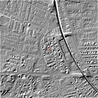 Shaded relief map of the ground around M210BP, computed from Environment Agency LiDAR. The ground here sits at about 29 m above sea level and falls 7 m across the surrounding 800 m. Surface water reaching this point runs off ground lying to the west-north-west, 2.7 m higher.