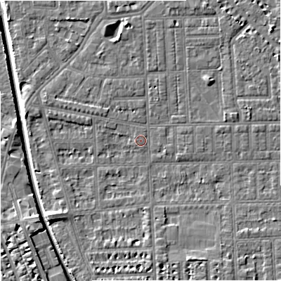 Shaded relief map of the ground around M210RA, computed from Environment Agency LiDAR. The ground here sits at about 28 m above sea level and falls 7 m across the surrounding 800 m. Surface water reaching this point runs off ground lying to the north-north-east, 2.7 m higher.