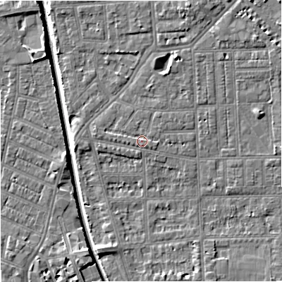Shaded relief map of the ground around M210RN, computed from Environment Agency LiDAR. The ground here sits at about 29 m above sea level and falls 7 m across the surrounding 800 m. Surface water reaching this point runs off ground lying to the south, 1.0 m higher.