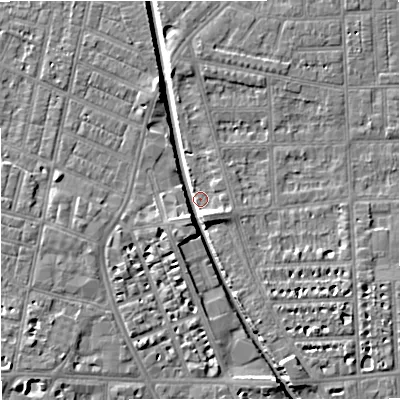Shaded relief map of the ground around M210RY, computed from Environment Agency LiDAR. The ground here sits at about 27 m above sea level and falls 7 m across the surrounding 800 m. Surface water reaching this point runs off ground lying to the south-south-east, 5.7 m higher.