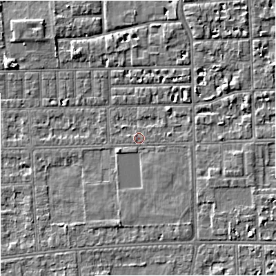 Shaded relief map of the ground around M210TU, computed from Environment Agency LiDAR. The ground here sits at about 29 m above sea level and falls 5 m across the surrounding 800 m. Surface water reaching this point runs off ground lying to the south-east, 2.4 m higher.