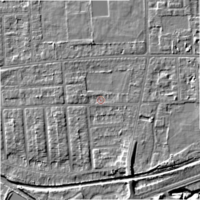 Shaded relief map of the ground around M210XX, computed from Environment Agency LiDAR. The ground here sits at about 29 m above sea level and falls 9 m across the surrounding 800 m. Surface water reaching this point runs off ground lying to the south-south-east, 4.8 m higher.