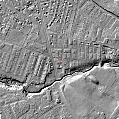 Shaded relief map of the ground around M218AY, computed from Environment Agency LiDAR. The ground here sits at about 28 m above sea level and falls 7 m across the surrounding 800 m. Surface water reaching this point runs off ground lying to the north-east, 1.8 m higher.