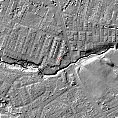 Shaded relief map of the ground around M218BZ, computed from Environment Agency LiDAR. The ground here sits at about 29 m above sea level and falls 8 m across the surrounding 800 m. Surface water reaching this point runs off ground lying to the north-north-west, 1.3 m higher.