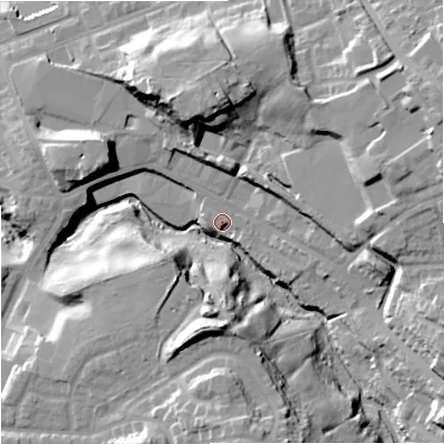 Shaded relief map of the ground around M242RG, computed from Environment Agency LiDAR. The ground here sits at about 87 m above sea level and falls 28 m across the surrounding 800 m. Surface water reaching this point runs off ground lying to the east-north-east, 18.6 m higher.