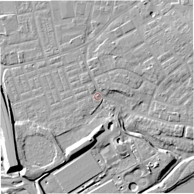 Shaded relief map of the ground around M307DR, computed from Environment Agency LiDAR. The ground here sits at about 21 m above sea level and falls 16 m across the surrounding 800 m. Surface water reaching this point runs off ground lying to the east-north-east, 3.7 m higher.
