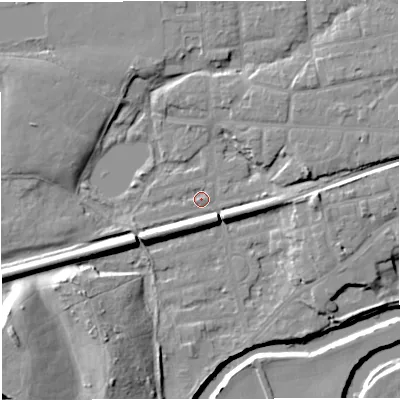 Shaded relief map of the ground around M416PR, computed from Environment Agency LiDAR. The ground here sits at about 16 m above sea level and falls 20 m across the surrounding 800 m. Surface water reaching this point runs off ground lying to the south-west, 6.5 m higher.